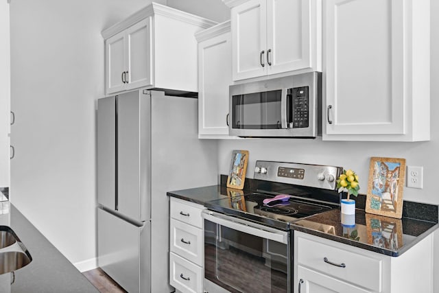 516 Main St, Burns, TN 37029 - kitchen featuring stainless steel appliances, white cabinets, and dark stone counters