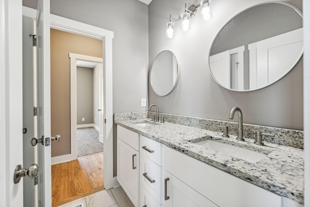 43 Long Branch Rd, Lawrenceburg, TN 38464 - bathroom with double vanity, baseboards, and wood finished floors