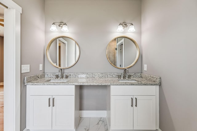 43 Long Branch Rd, Lawrenceburg, TN 38464 - full bath with double vanity, marble look tile flooring, and baseboards