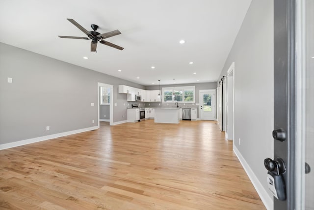 47 Long Branch Rd, Lawrenceburg, TN 38464 - unfurnished living room with a ceiling fan, recessed lighting, light wood-style flooring, baseboards, and a sink