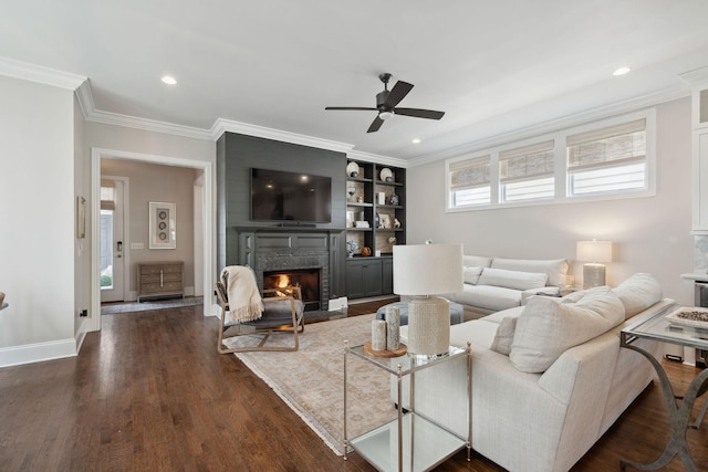 82 Addison Ave, Franklin, TN 37064 - living area with ceiling fan, a fireplace with flush hearth, ornamental molding, dark wood finished floors, and built in shelves