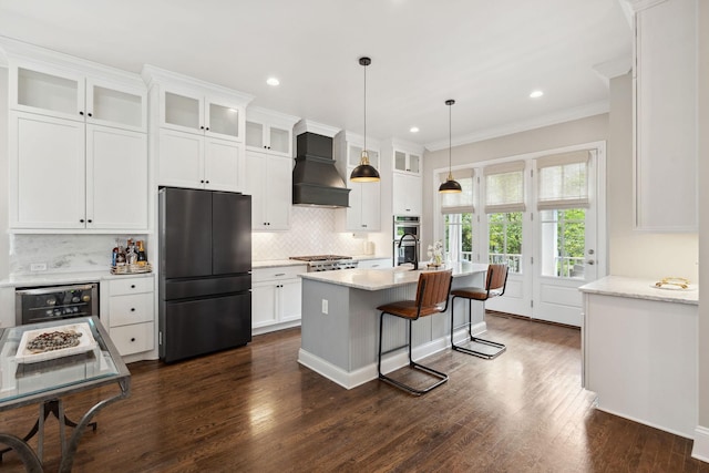 82 Addison Ave, Franklin, TN 37064 - kitchen with stainless steel appliances, custom exhaust hood, wine cooler, white cabinets, and decorative backsplash