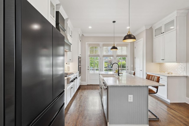 82 Addison Ave, Franklin, TN 37064 - kitchen featuring refrigerator, dark wood finished floors, an island with sink, decorative backsplash, and ornamental molding
