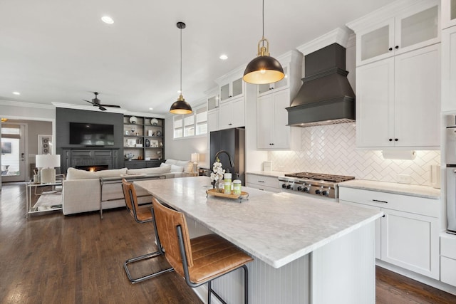 82 Addison Ave, Franklin, TN 37064 - kitchen featuring ceiling fan, custom range hood, appliances with stainless steel finishes, plenty of natural light, and ornamental molding