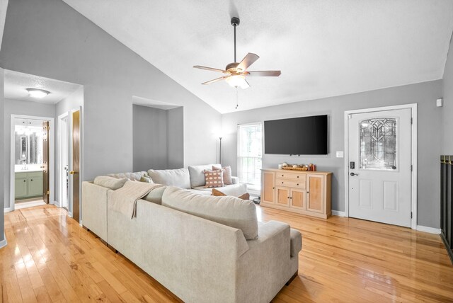 517 Ginkgo Dr, Clarksville, TN 37042 - living area featuring light wood-type flooring, a ceiling fan, baseboards, and high vaulted ceiling