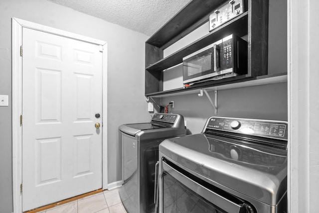 517 Ginkgo Dr, Clarksville, TN 37042 - washroom featuring independent washer and dryer, a textured ceiling, and light tile patterned flooring