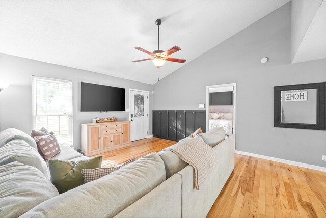 517 Ginkgo Dr, Clarksville, TN 37042 - living room with light wood-type flooring, ceiling fan, baseboards, and high vaulted ceiling