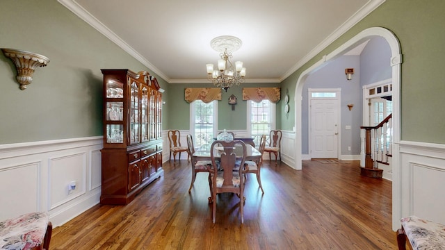 103 Doral Ln, Hendersonville, TN 37075 - dining space featuring a chandelier, dark wood-type flooring, ornamental molding, a wainscoted wall, and arched walkways
