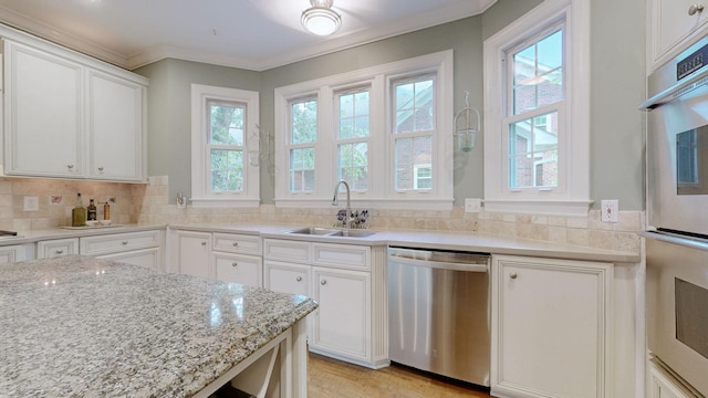 103 Doral Ln, Hendersonville, TN 37075 - kitchen featuring appliances with stainless steel finishes, a sink, plenty of natural light, white cabinets, and crown molding