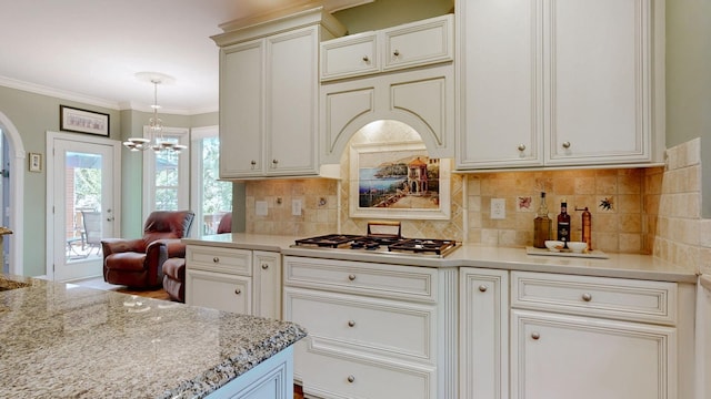 103 Doral Ln, Hendersonville, TN 37075 - kitchen featuring a chandelier, decorative backsplash, arched walkways, stainless steel gas stovetop, and light stone countertops