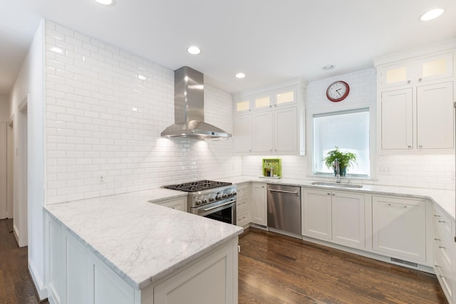 143 Prospect Hl, Nashville, TN 37205 - kitchen with wall chimney exhaust hood, stainless steel appliances, a sink, backsplash, and recessed lighting