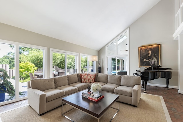 143 Prospect Hl, Nashville, TN 37205 - living room featuring high vaulted ceiling, baseboards, and brick floors