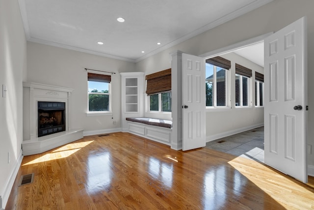 3840 SE Tater Peeler Rd, Lebanon, TN 37090 - unfurnished living room with ornamental molding, wood finished floors, baseboards, a fireplace with raised hearth, and recessed lighting