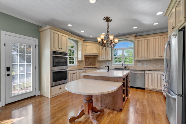 3840 SE Tater Peeler Rd, Lebanon, TN 37090 - kitchen featuring stainless steel appliances, cream cabinetry, a chandelier, premium range hood, and a kitchen island