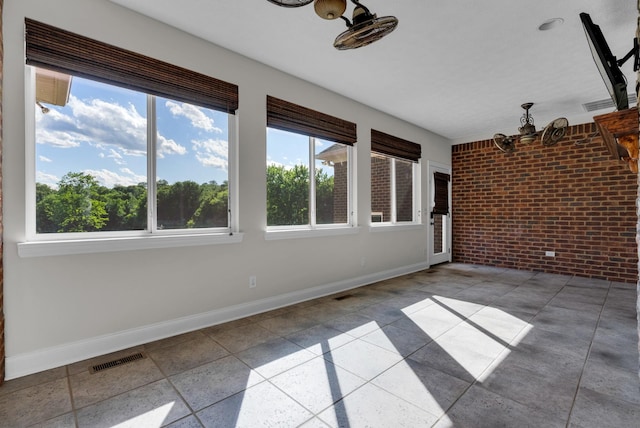 3840 SE Tater Peeler Rd, Lebanon, TN 37090 - unfurnished sunroom featuring brick wall, baseboards, and a chandelier