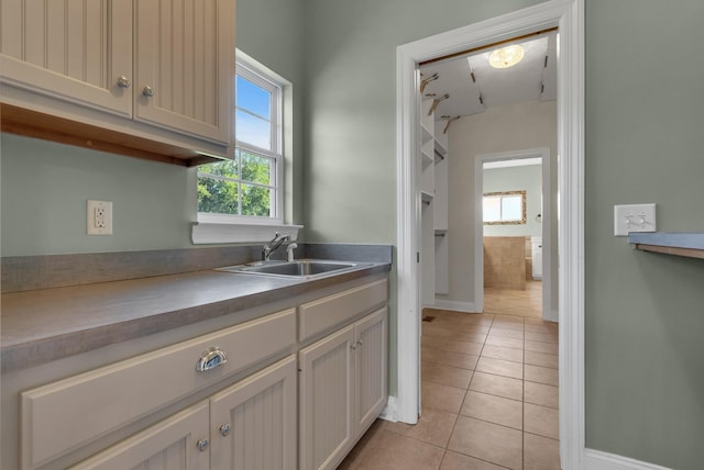 3840 SE Tater Peeler Rd, Lebanon, TN 37090 - kitchen featuring a sink, light tile patterned floors, and baseboards
