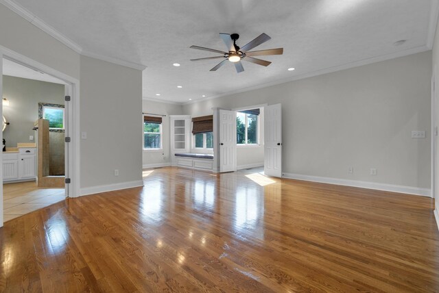 3840 SE Tater Peeler Rd, Lebanon, TN 37090 - unfurnished living room with crown molding, a ceiling fan, light wood-type flooring, baseboards, and recessed lighting
