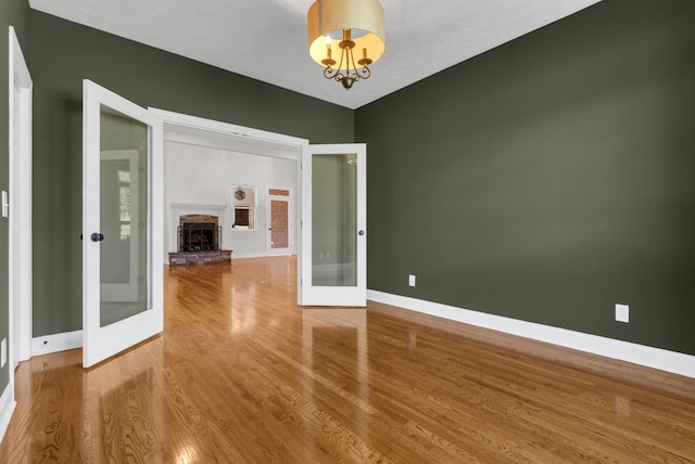 3840 SE Tater Peeler Rd, Lebanon, TN 37090 - empty room featuring french doors, baseboards, and wood finished floors