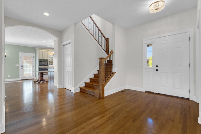 3840 SE Tater Peeler Rd, Lebanon, TN 37090 - foyer entrance with arched walkways, wood finished floors, stairs, baseboards, and recessed lighting