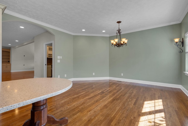 3840 SE Tater Peeler Rd, Lebanon, TN 37090 - unfurnished dining area featuring a chandelier, wood finished floors, arched walkways, recessed lighting, and baseboards