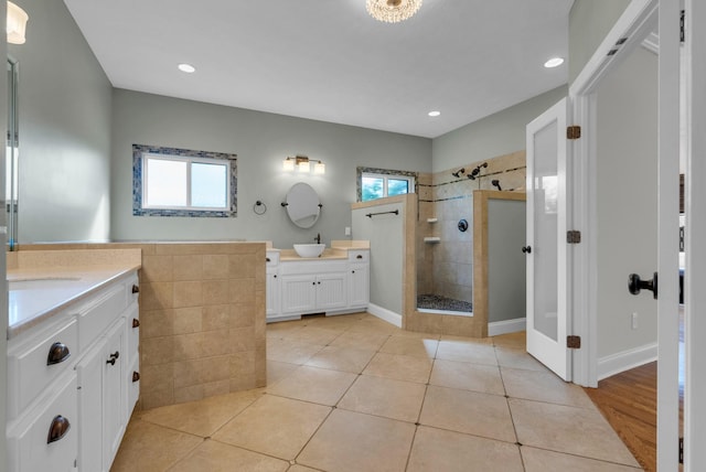 3840 SE Tater Peeler Rd, Lebanon, TN 37090 - full bath with plenty of natural light, a tile shower, two vanities, tile patterned flooring, and recessed lighting