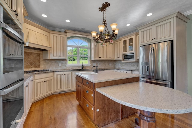 3840 SE Tater Peeler Rd, Lebanon, TN 37090 - kitchen with cream cabinetry, appliances with stainless steel finishes, recessed lighting, a center island, and a chandelier
