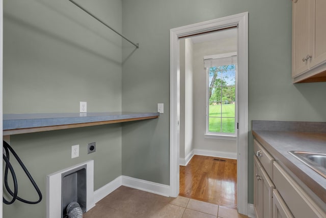 3840 SE Tater Peeler Rd, Lebanon, TN 37090 - laundry area with baseboards, light tile patterned floors, hookup for an electric dryer, and cabinet space