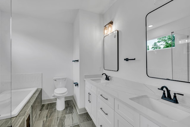 730 Old Hickory Blvd Unit 224, Nashville, TN 37209 - bathroom featuring double vanity, tiled tub, toilet, and baseboards