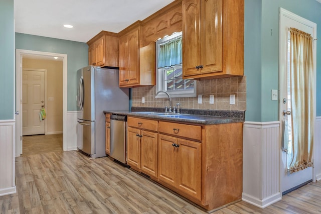 2137 Horton Way, Lewisburg, TN 37091 - kitchen featuring stainless steel appliances, a sink, dark countertops, brown cabinetry, and wainscoting