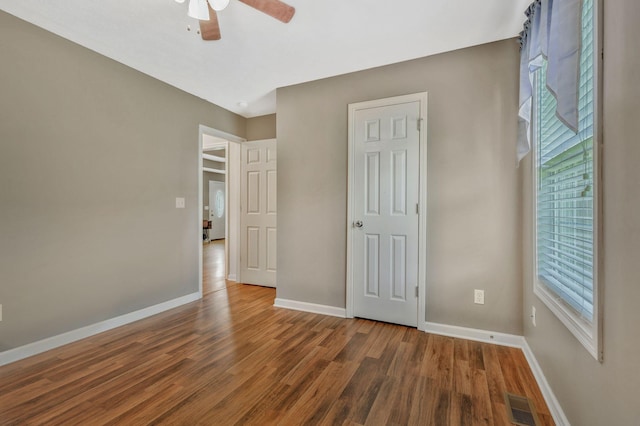 2137 Horton Way, Lewisburg, TN 37091 - unfurnished bedroom with baseboards, wood finished floors, multiple windows, and ceiling fan