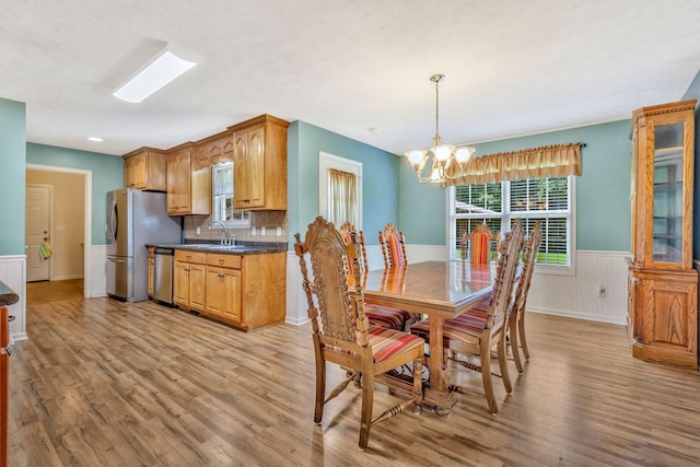 2137 Horton Way, Lewisburg, TN 37091 - dining area featuring light wood finished floors, a chandelier, and wainscoting