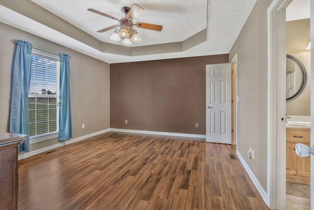 2137 Horton Way, Lewisburg, TN 37091 - unfurnished bedroom featuring wood finished floors, baseboards, a tray ceiling, and ceiling fan
