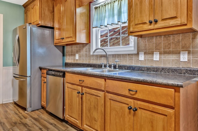 2137 Horton Way, Lewisburg, TN 37091 - kitchen featuring appliances with stainless steel finishes, a sink, dark countertops, light wood-style flooring, and brown cabinetry
