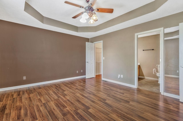 2137 Horton Way, Lewisburg, TN 37091 - unfurnished bedroom with a tray ceiling, wood finished floors, baseboards, a walk in closet, and ensuite bathroom
