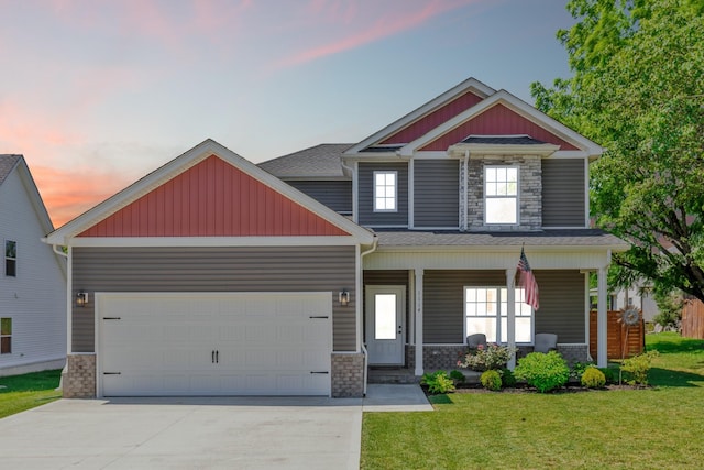 1114 Johnson St, Burns, TN 37029 - craftsman-style home featuring an attached garage, a front yard, concrete driveway, covered porch, and stone siding