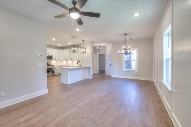 9067 Headwaters Dr Unit 141, Franklin, TN 37064 - unfurnished living room with a chandelier, recessed lighting, ceiling fan, baseboards, and wood finished floors