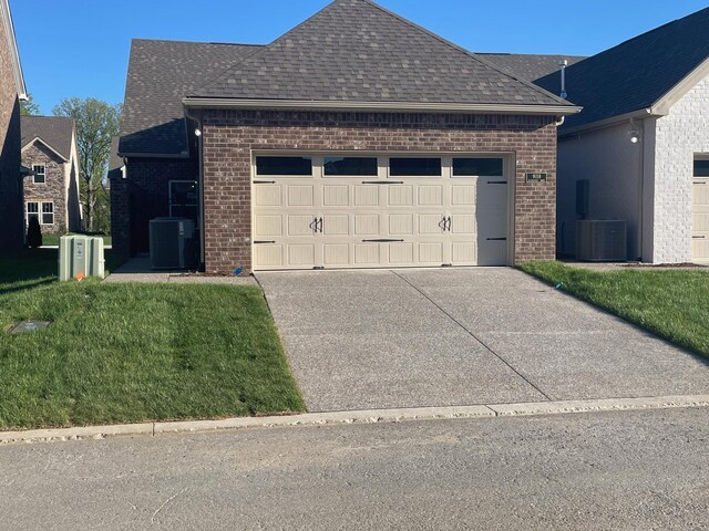 9067 Headwaters Dr Unit 141, Franklin, TN 37064 - traditional home with brick siding, roof with shingles, a garage, concrete driveway, and central AC unit