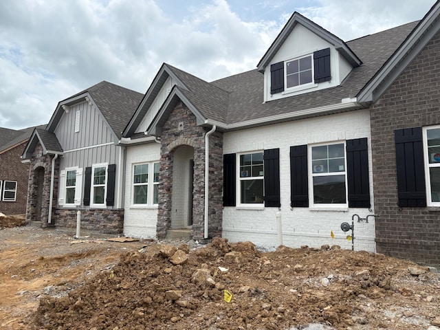 9073 Headwaters Dr Unit 142, Franklin, TN 37064 - view of front facade featuring board and batten siding, roof with shingles, and brick siding