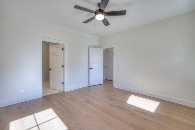 9073 Headwaters Dr Unit 142, Franklin, TN 37064 - unfurnished bedroom featuring light wood-style flooring, baseboards, ensuite bath, and a ceiling fan