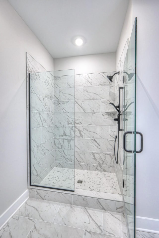 90883 Headwaters Dr Unit 143, Franklin, TN 37064 - full bathroom featuring baseboards, a shower stall, and marble look tile flooring