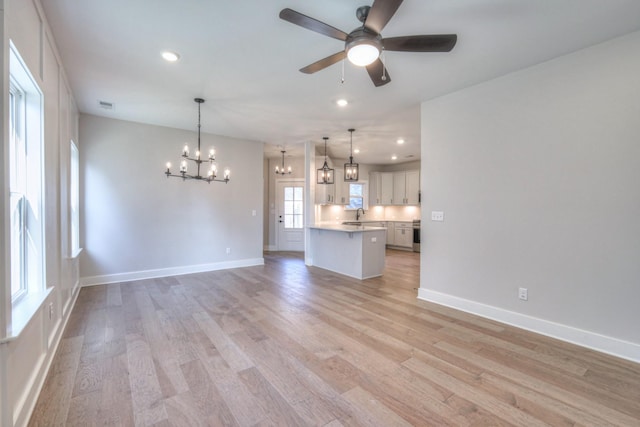 90883 Headwaters Dr Unit 143, Franklin, TN 37064 - unfurnished living room featuring a chandelier, ceiling fan, baseboards, light wood-type flooring, and recessed lighting
