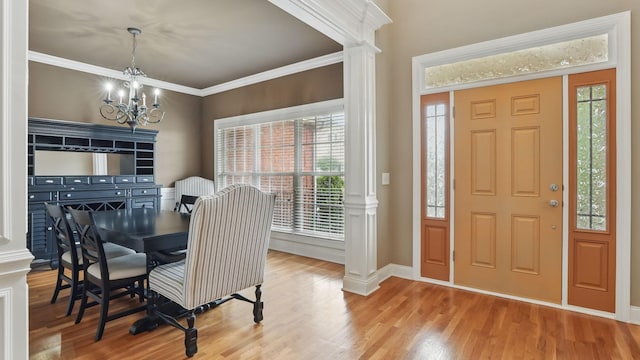 1023 Fitzroy Cir, Spring Hill, TN 37174 - dining room featuring a chandelier, wood finished floors, decorative columns, and crown molding