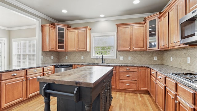 1023 Fitzroy Cir, Spring Hill, TN 37174 - kitchen featuring stainless steel appliances, light wood-style flooring, light stone counters, glass insert cabinets, and recessed lighting