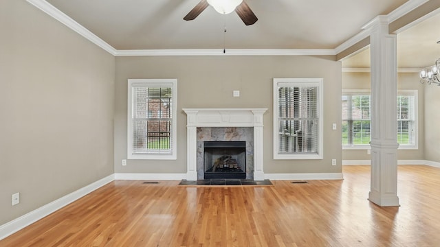 1023 Fitzroy Cir, Spring Hill, TN 37174 - unfurnished living room with light wood-type flooring, a tile fireplace, ornate columns, plenty of natural light, and crown molding