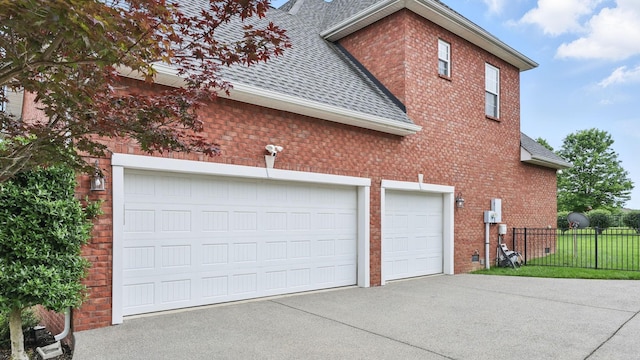 1023 Fitzroy Cir, Spring Hill, TN 37174 - view of side of property with roof with shingles, concrete driveway, brick siding, and a garage