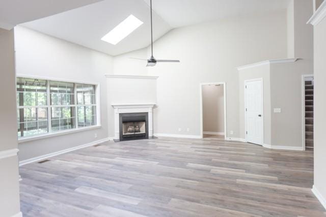 6356 Paddington Way, Antioch, TN 37013 - unfurnished living room featuring a fireplace, high vaulted ceiling, wood finished floors, ceiling fan, and baseboards