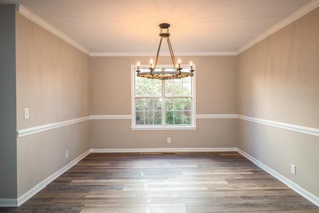 6356 Paddington Way, Antioch, TN 37013 - spare room featuring a chandelier, wood finished floors, baseboards, and ornamental molding