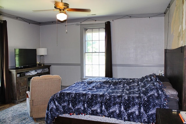 211 Maple St E, Fayetteville, TN 37334 - bedroom featuring a wainscoted wall, wood finished floors, and a ceiling fan