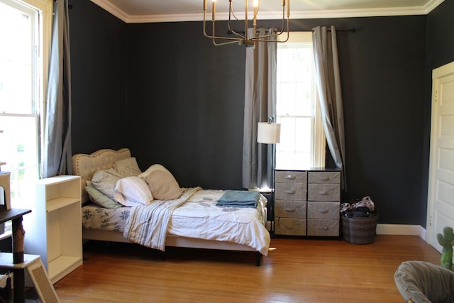 211 Maple St E, Fayetteville, TN 37334 - bedroom with crown molding, a chandelier, wood finished floors, and baseboards