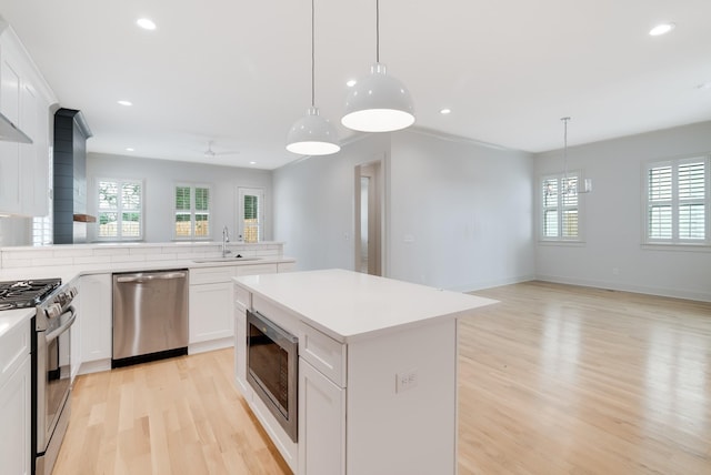 674B Westboro Dr, Nashville, TN 37209 - kitchen with appliances with stainless steel finishes, a sink, light wood-type flooring, recessed lighting, and light countertops